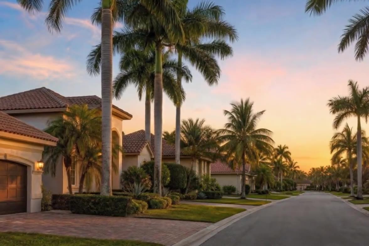 A palm lined South Florida estate street at sunset